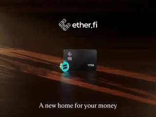 An ether.fi Visa card and a glowing coin on a dark wooden surface under the ether.fi logo, with the line A new home for your money