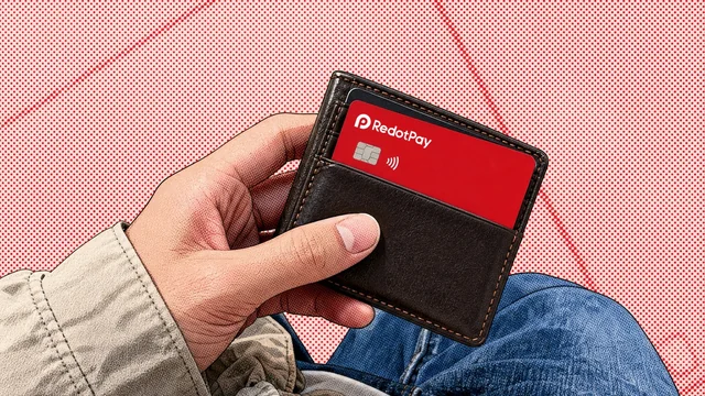Hand holding a wallet with a red RedotPay card in its front pocket
