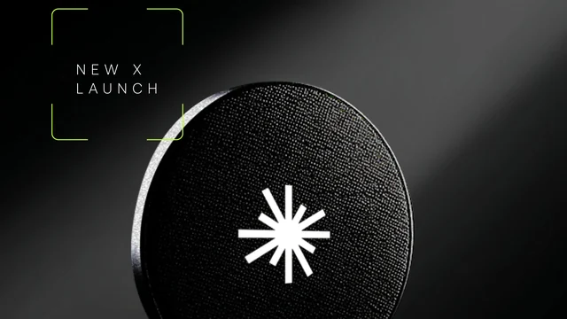 Black coin with the white Axis Robotics star mark under a beam of light, beside a green-framed label reading New X Launch
