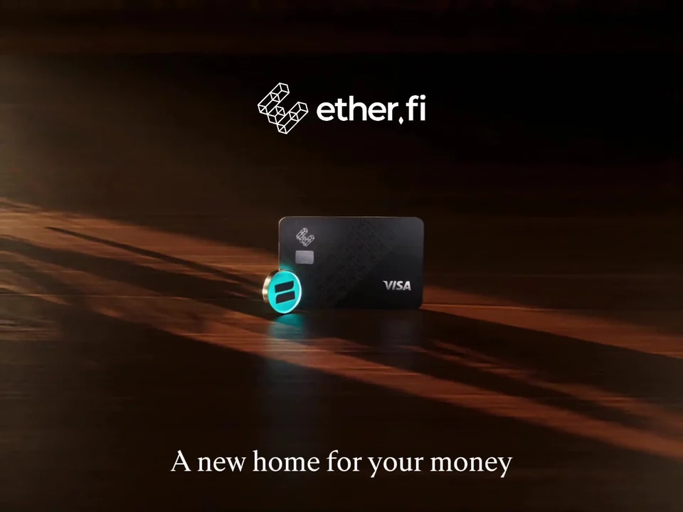 An ether.fi Visa card and a glowing coin on a dark wooden surface under the ether.fi logo, with the line A new home for your money