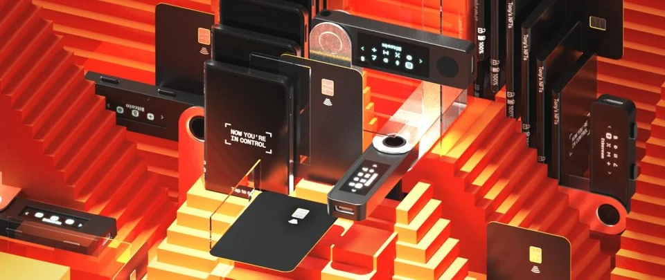 Ledger hardware wallets and recovery accessories on orange blocks