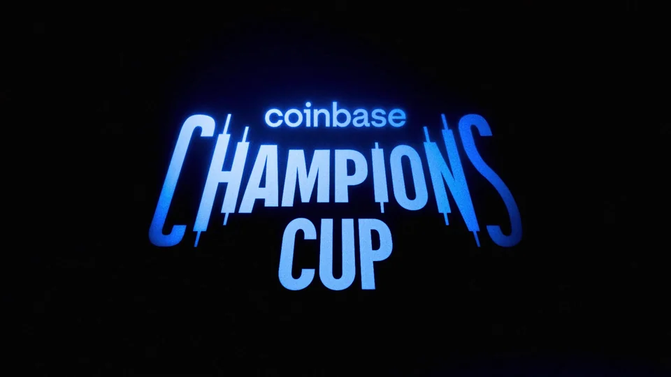 Glowing blue Coinbase Champions Cup logo on a dark background