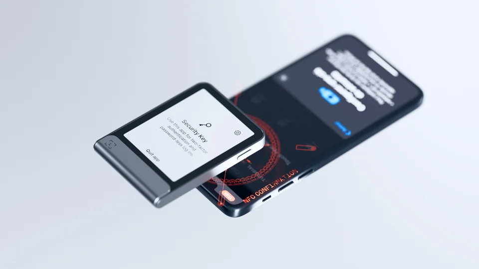 Ledger touchscreen signer showing the Security Key app, held over a phone displaying an NFC confirmation
